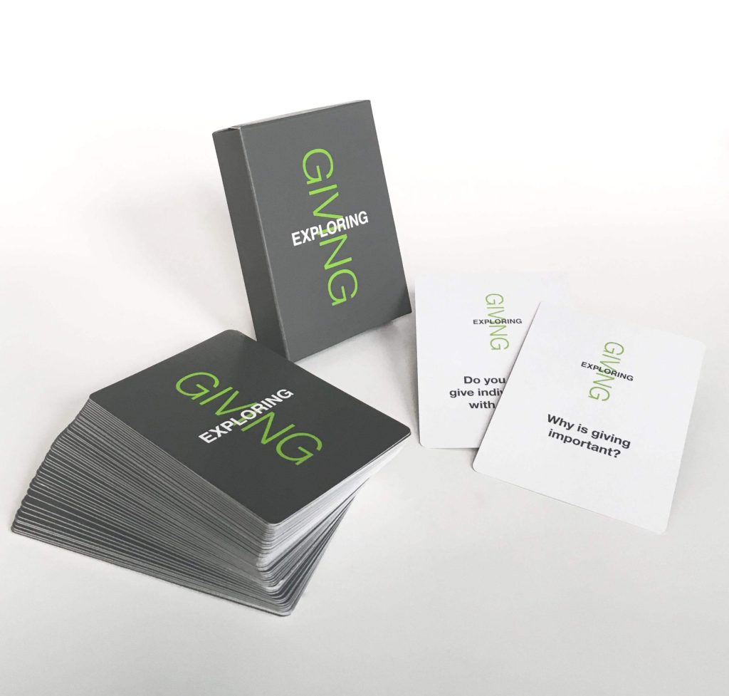 A deck of cards titled EXPLORING GIVING is shown, with several cards spread out. Two visible cards have the questions: Why is giving important? and Do you give individually or with others?.